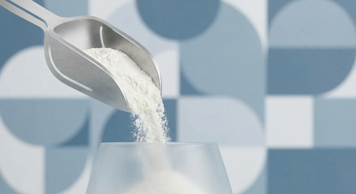 Fine WPI 90 powder being scooped, showing its smooth and consistent texture